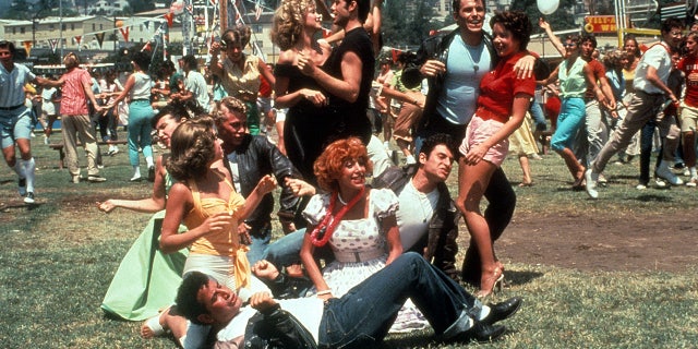 The cast of Grease in the carnival scene