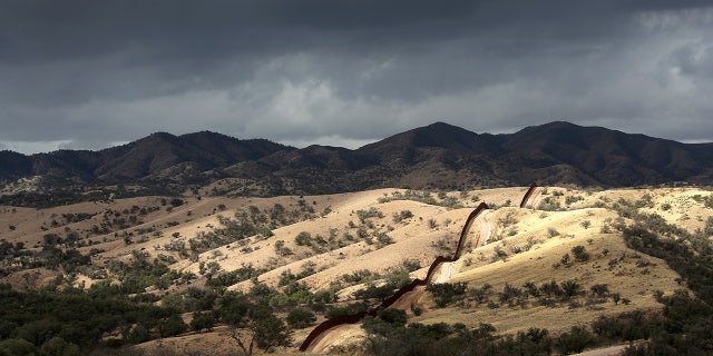 The U.S.-Mexico border fence stretches into the countryside near Nogales, Arizona. 