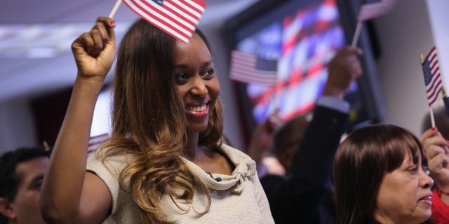 Rwandan immigrant and genocide survivor Immaculee Ilibagiza celebrates after taking the oath of American citizenship at a naturalization ceremony on April 17, 2013 in New York City.