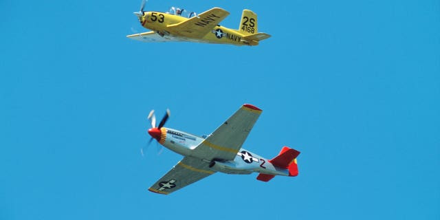 Minnesota, South St Paul. Fleming Field Minnesota Wing CAF Air Show, North American P-51C Tuskegee Airmen Red Tail and T-34C Turbo Mentor.