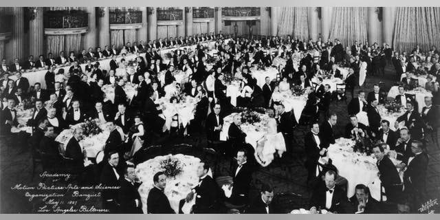 A look at the first organizational meeting of the Academy of Motion Picture Arts and Sciences in the Crystal Ballroom of the Los Angeles Biltmore Hotel. Mary Pickford, Douglas Fairbanks, Louis B. Mayer, Jack L. Warner and Darryl F. Zanuck attended the banquet and were early founders of the Academy