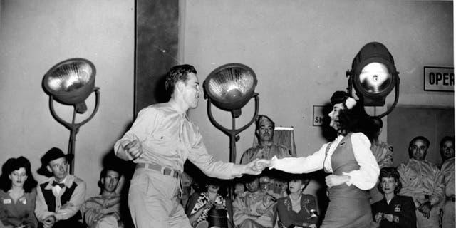 An American serviceman dancing the jitterbug with a young woman in 1944. Americans danced to the sounds of Glenn Miller during the war years.