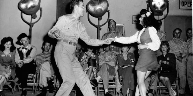 An American serviceman dancing the jitterbug with a young woman in 1944. Americans danced to the sounds of Glenn Miller during the war years.