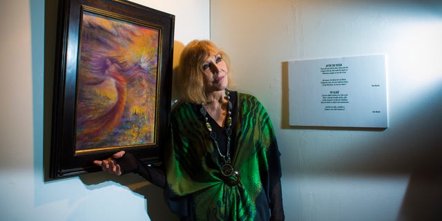 Kim Novak standing beside one of her art pieces in 2015.