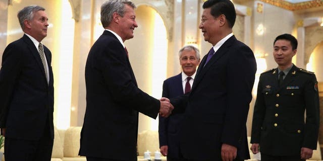 BEIJING, CHINA - APRIL 09:  U.S. Ambassador to China Max Baucus (2L) shakes hands with Chinese President Xi Jinping (4L) as Secretary of Defense Chuck Hagel (3L) looks on during a meeting at the Great Hall of the People April 9, 2014 in Beijing, China. Secretary Hagel is on the second stop of an Asian trip, the fourth time since he took office, to Japan, China and Mongolia.  