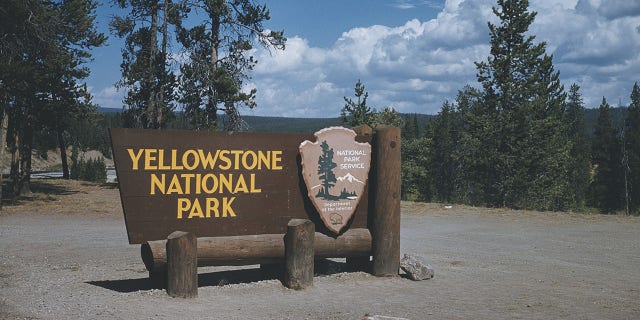 A sign at the south entrance to Yellowstone National Park, Wyoming, courtesy of the National Park Service, Department of the Interior, circa 1965.