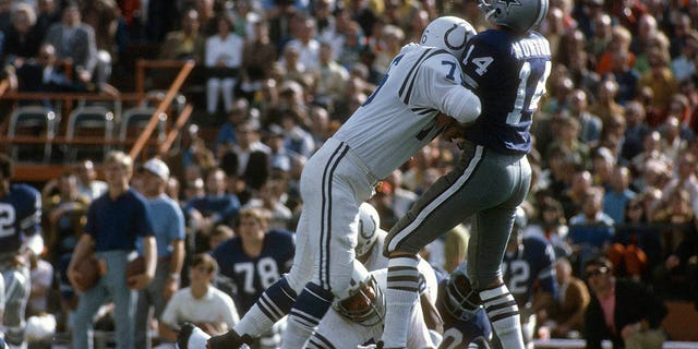 Fred Miller, #76 of the Baltimore Colts, hits quarterback Craig Morton, #14 of the Dallas Cowboys, during Super Bowl V Jan. 17, 1971 at the Orange Bowl in Miami. The Colts won the game 16 -13. 