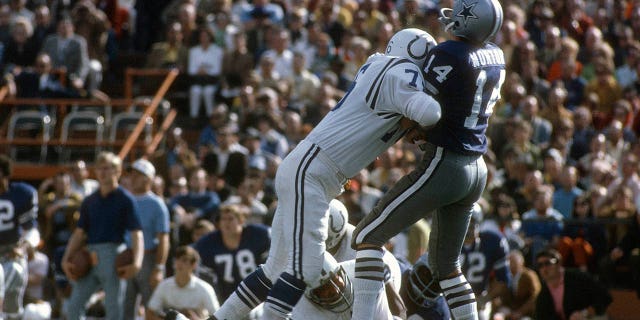 Fred Miller, #76 of the Baltimore Colts, hits quarterback Craig Morton, #14 of the Dallas Cowboys, during Super Bowl V on January 17, 1971 at the Orange Bowl in Miami.  The Colts won the game 16 -13. 