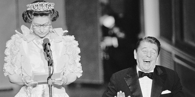 President Reagan laughs following a joke by Queen Elizabeth II, who commented on the lousy California weather she experienced during her time in the United States, March 1983. 