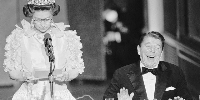 President Reagan laughs at a joke by Queen Elizabeth II, who commented on the bad California weather she experienced while in the United States in March 1983.