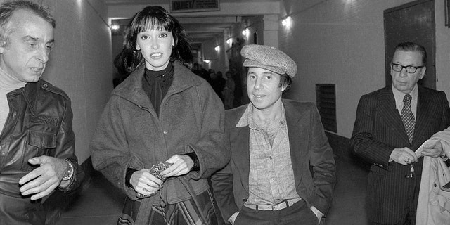 Actress Shelley Duvall and musician Paul Simon leave a theater after seeing Broadway hit "The Gin Game" in 1977.