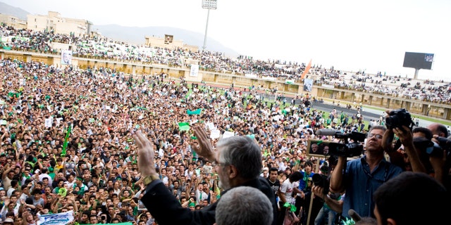 Mir Hossein Mousavi, a reformist candidate in Iran's presidential elections in 2009, waves to supporters during a campaign rally in Karaj, Iran on June 6, 2009. (Ramin Talaie/Corbis via Getty Images)