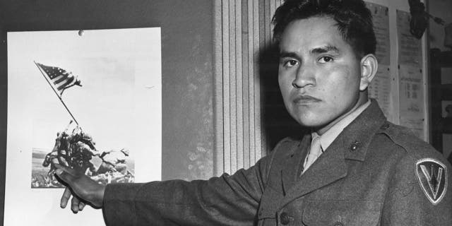 Marine Private First Class Ira Hayes points himself out in the historic picture of the flag raising on Mount Suribachi, Iwo Jima, 1945.