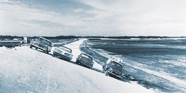 Before the asphalt was laid, Bill France Sr., and members of his NASCAR staff parked these cars on a turn of the under-construction Daytona International Speedway in December 1958. France gambled nearly everything he owned in building the facility that is known as "The World Center of Racing." 