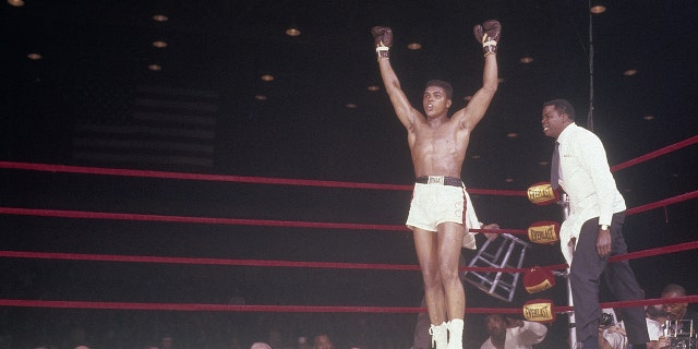 Cassius Clay throws his hands up successful triumph complete Sonny Liston (not pictured) successful their World Heavyweight Title conflict connected Feb. 25, 1964, successful Miami, Florida.