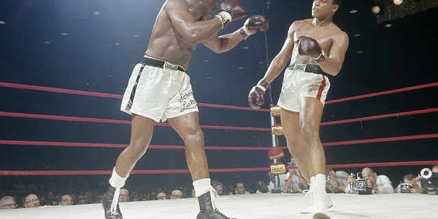 Cassius Clay, right, successful action vs. Sonny Liston successful nan World Heavyweight Title conflict connected Feb. 25, 1964, astatine Convention Hall successful Miami, Florida.