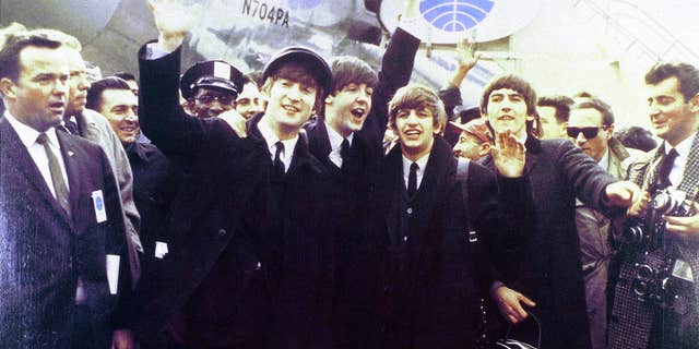 UNITED STATES - FEB. 07: (AUSTRALIA OUT): Photo of the Beatles — from left to right, John Lennon, Paul McCartney, Ringo Starr and George Harrison — waving at crowds as they arrive at JFK Airport for their first U.S. tour. 
