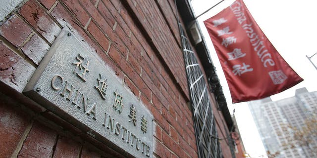 A plaque and a flag hang outside the China Institute, home of the Confucius Institute, in New York.