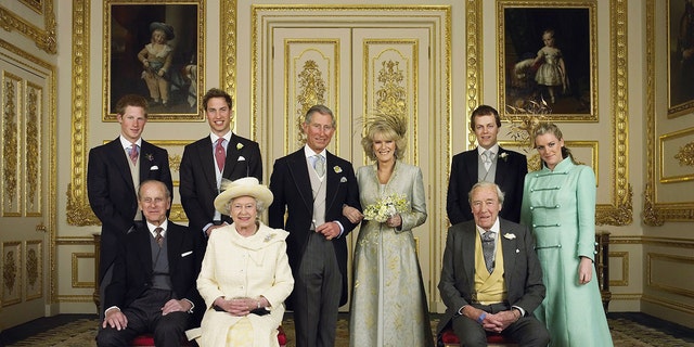 The Prince of Wales and his new bride Camilla, Duchess of Cornwall, with their families (L-R back row) Prince Harry, Prince William, Tom and Laura Parker Bowles (L-R front row) Duke of Edinburgh, Britain's Queen Elizabeth II and Camilla's father Major Bruce Shand, in the White Drawing Room at Windsor Castle after their wedding ceremony, April 9, 2005, in Windsor, England.