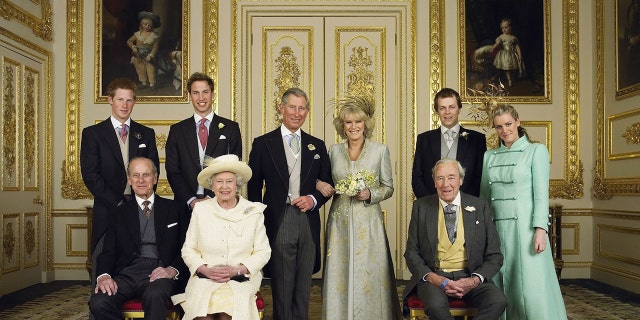 The Prince of Wales and his new bride Camilla, Duchess of Cornwall, with their families (L-R back row) Prince Harry, Prince William, Tom and Laura Parker Bowles (L-R front row) Duke of Edinburgh, Britain's Queen Elizabeth II and Camilla's father Major Bruce Shand, in the White Drawing Room at Windsor Castle after their wedding ceremony, April 9, 2005, in Windsor, England.