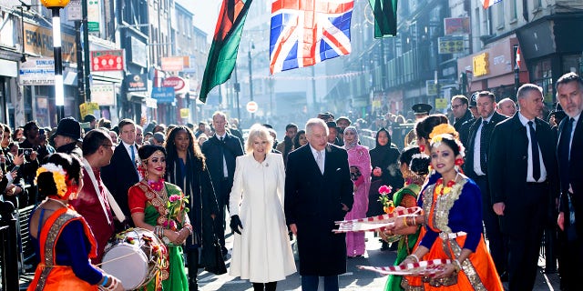 King Charles III and Camilla, queen consort, meet members of the public during a visit to the Bangladeshi community of Brick Lane Feb. 8, 2023, in London.