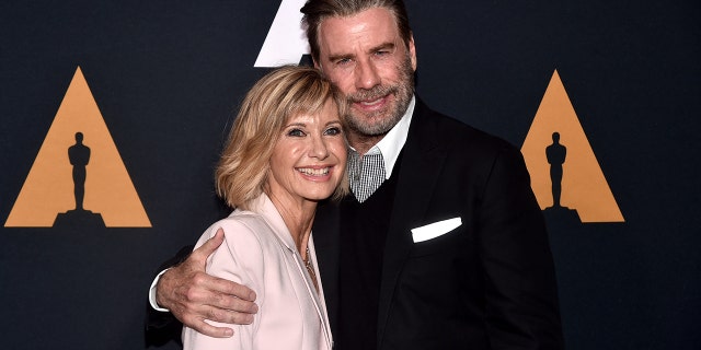 Olivia Newton-John and John Travolta attend the "Grease" 40th anniversary screening at Samuel Goldwyn Theater on Aug. 15, 2018, in Beverly Hills, California. The actress passed away in 2022 at age 73.