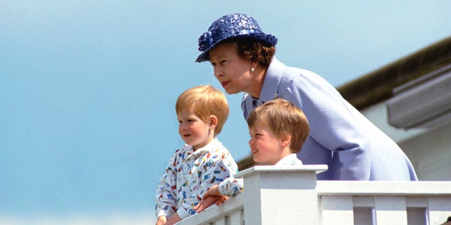 Queen Elizabeth II with a young Prince William, right, and Prince Harry. Britain's longest-reigning monarch passed away in September 2022 at age 96.