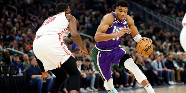 Giannis Antetokounmpo of the Milwaukee Bucks, right, dribbles the ball to the basket during the first half of a game against the Miami Heat at Fiserv Forum Feb. 24, 2023, in Milwaukee.