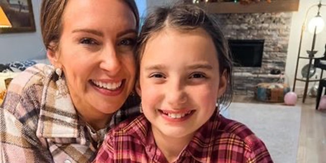 Ginny Lauren Dowden, shown with her daughter, Rosalyn, fought for her little girl to remain mask-free despite school mask mandates in their town of Fayetteville, Arkansas. 
