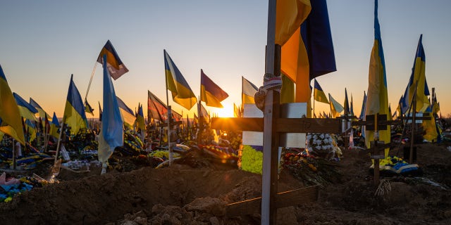 Ukrainian flags are planted in the graves of soldiers at a Kharkiv cemetery on Jan. 24, 2023 in Kharkiv, Ukraine.