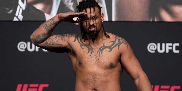 Greg Hardy poses on the scale during the UFC 272 official weigh-in at UFC APEX on March 4, 2022, in Las Vegas, Nevada.