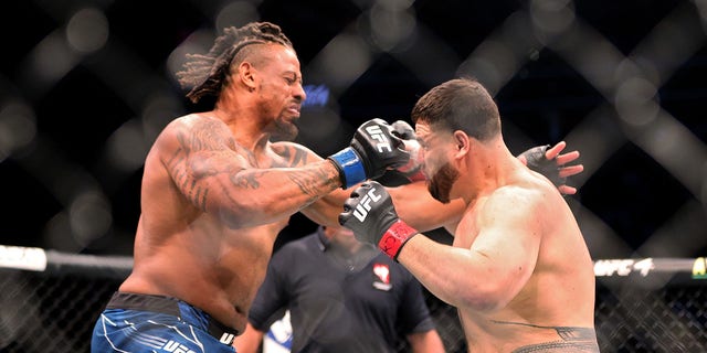 Greg Hardy (L) and Australia's Tai Tuivasa exchange blows in the first round of their heavyweight bout during UFC 264: Poirier vs.  McGregor 3 at T-Mobile Arena on July 10, 2021 in Las Vegas, Nevada.