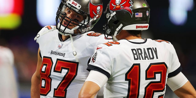 Tom Brady y Rob Gronkowski de los Tampa Bay Buccaneers conversan antes del partido de los Falcons en el Mercedes-Benz Stadium el 5 de diciembre de 2021 en Atlanta.