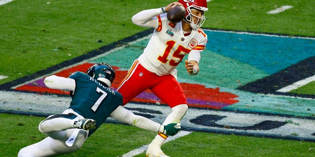 Haason Reddick of the Philadelphia Eagles attempts to tackle Patrick Mahomes of the Kansas City Chiefs in Super Bowl LVII at State Farm Stadium on Feb. 12, 2023, in Glendale, Arizona.