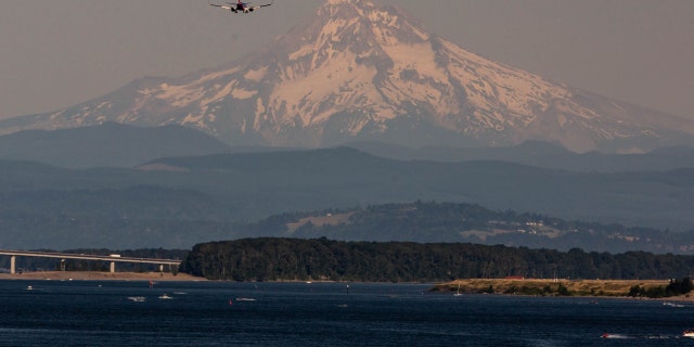 Mount Hood beyond the Willamette River during a heatwave in Portland, Oregon, U.S., on Monday, June 28, 2021. 