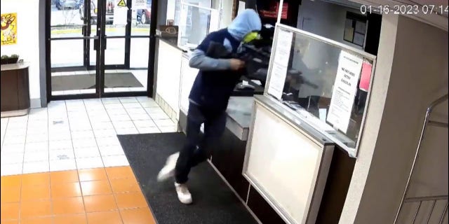 As the hotel clerk was being held at gunpoint with the rifle, police say that she pulled out a handgun of her own and pointed it at the suspect, who then fled the scene.