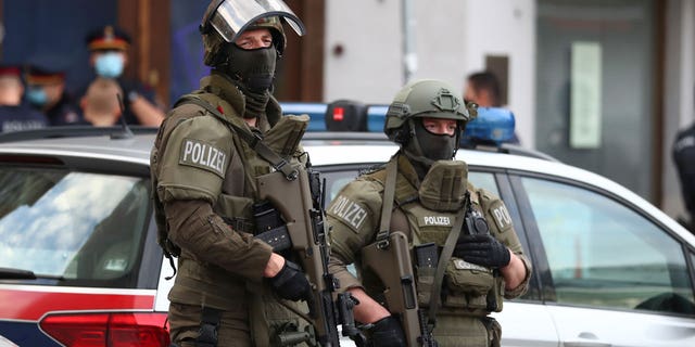 Police officers guard the scene of attack in Vienna, Austria, on Nov. 3, 2020.