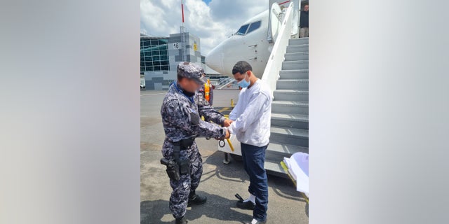 Noe David Alvarez Escamilla, a 24-year-old Salvadoran national and documented 18th Street gang member, is handcuffed by law enforcement officers from El Salvador’s Civilian National Police (PNC) after he was removed from the U.S. by ICE. 