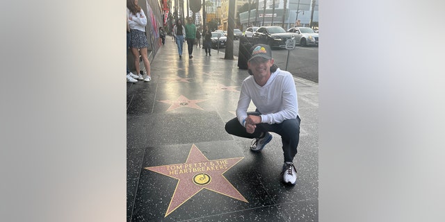 One of his favorite artists to listen to during his walk was Tom Petty and the Heartbreakers, Pasquale said. Above, he checks out the band's star on the Hollywood Walk of Fame in Hollywood, California.