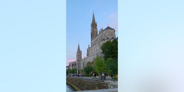 The Basilica of the Immaculate Conception as seen from the riverbank in Lourdes, France.