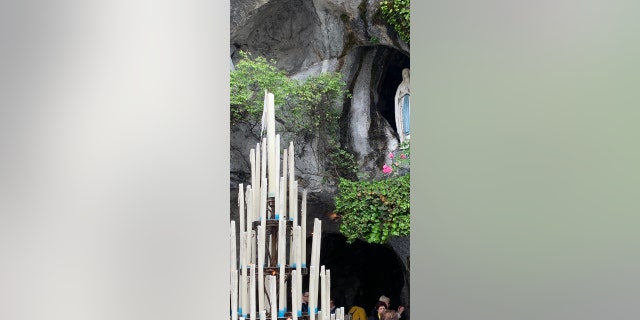 A statue of the Virgin Mary stands in the niche where Catholics believe she appeared to St. Bernadette Soubirous in 1858. Fr. John Hollowell of Indiana believes he was healed of his brain tumor after he visited Lourdes.