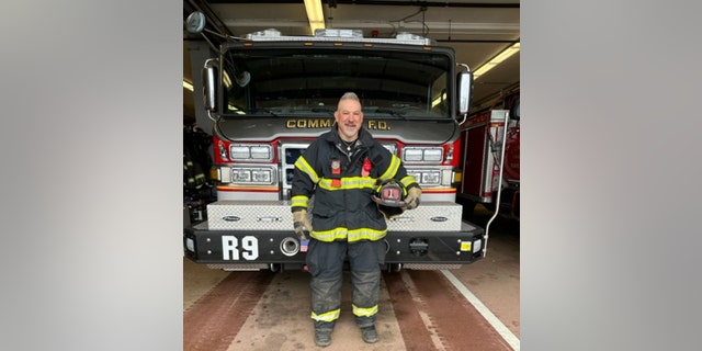 Weisberg stands proudly in front of a Commack Fire Department truck in Commack, New York, on Feb. 28, 2023.