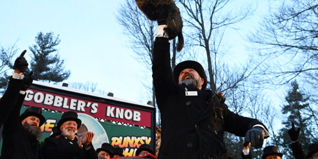 Groundhog Club handler A.J. Dereume holds Punxsutawney Phil, the weather prognosticating groundhog, during the 136th celebration of Groundhog Day on Gobbler's Knob in Punxsutawney, Pa., Feb. 2, 2022. 