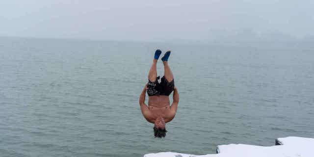"The Great Lake Jumper" Dan O'Conor takes a plunge into the waters of Lake Michigan on Jan. 26, 2023, in Chicago, Illinois.