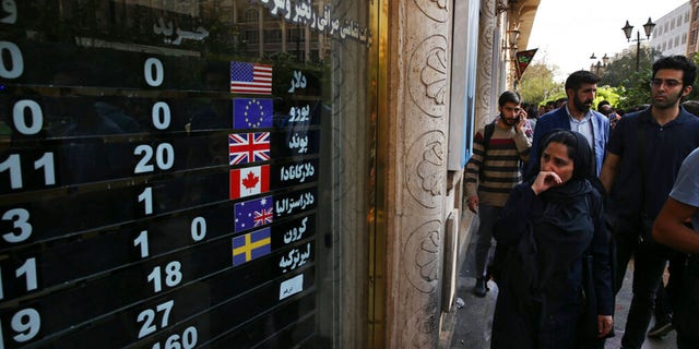 FILE: An exchange shop displays rates for various currencies, in downtown Tehran, Iran, Tuesday, Oct. 2, 2018. 