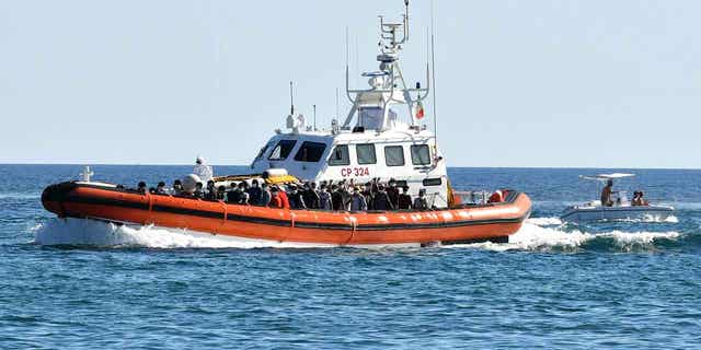 Un barco de la guardia costera italiana con inmigrantes a bordo