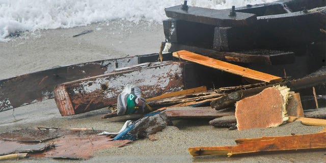 Shoes seen among the wreckage of a migrant boat washed ashore at a beach near Cutro, southern Italy, Sunday, Feb. 26, 2023. 