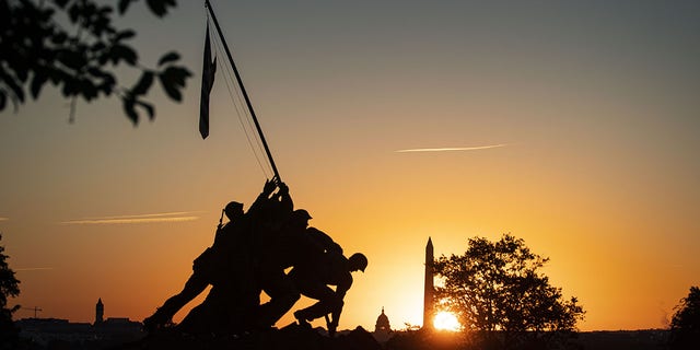 The U.S. Marine Corp Iwo Jima Memorial in front of the U.S. Capitol, center, and Washington Monument, right, in Arlington, Virginia, on Sept. 27, 2021. 