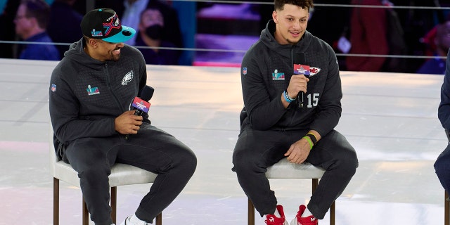 Jalen Hurts #1 of the Philadelphia Eagles speaks with Patrick Mahomes #15 of the Kansas City Chiefs at Footprint Center on February 6, 2023 in Phoenix, Arizona.