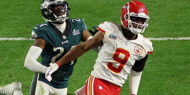 James Bradberry #24 of the Philadelphia Eagles is called for holding against JuJu Smith-Schuster #9 of the Kansas City Chiefs during the fourth quarter of Super Bowl LVII at State Farm Stadium on February 12, 2023 in Glendale, Arizona.